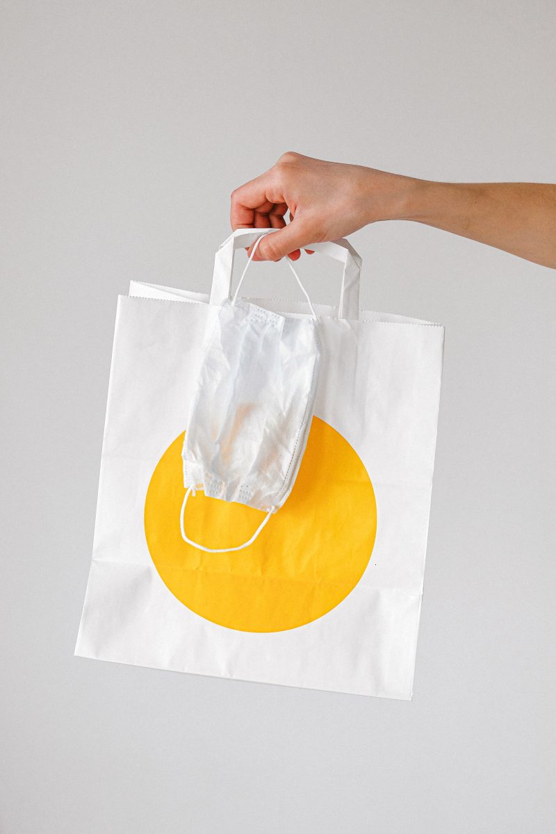 Canva - Person Holding Paper Bag and Face Mask